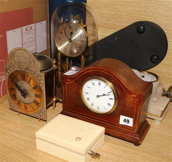 An Edwardian inlaid clock, an alabaster clock and two others